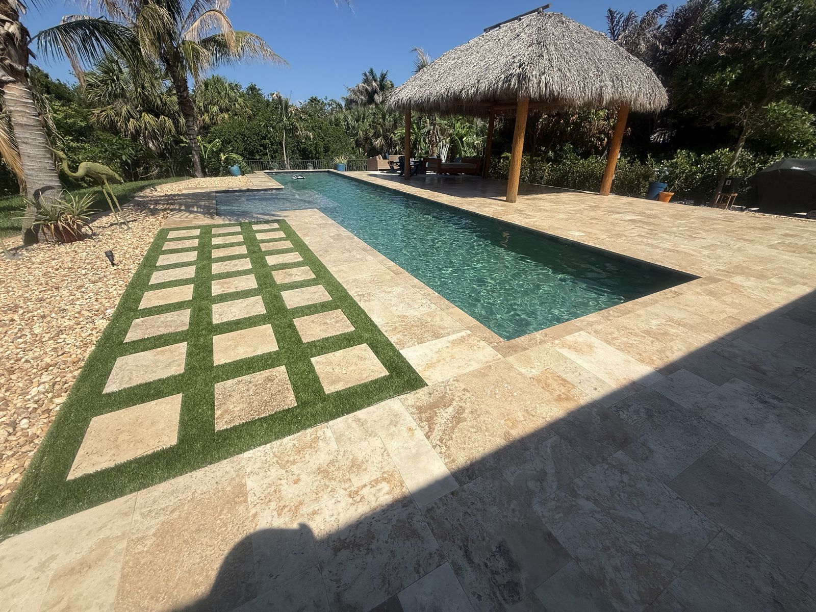 Travertine pool deck and turf installed by Groundworks